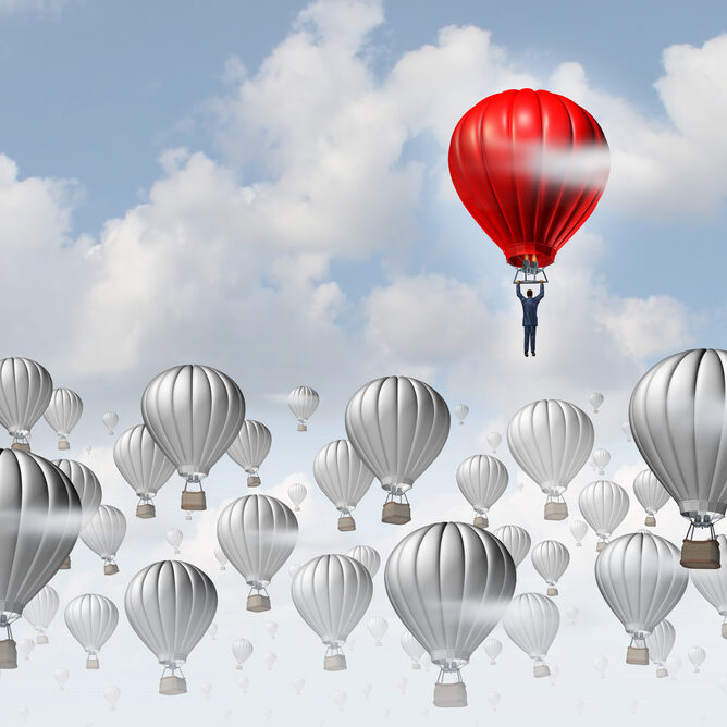 The best leadership concept with a group of grey hot air balloons in the sky and a red aircraft guided by a business leader rising above the competition as a success metaphor for leadership.